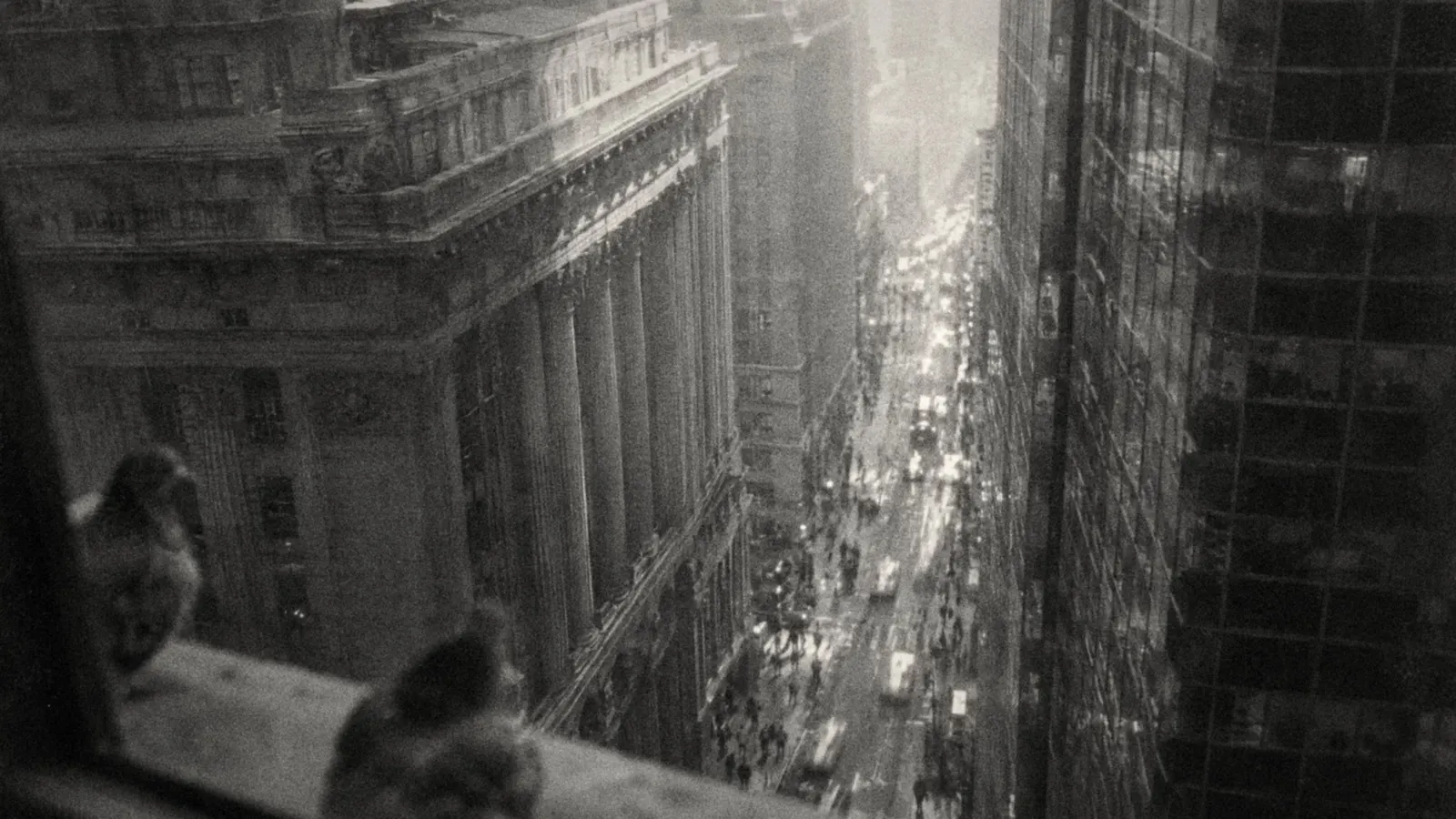 A street seen from above, with people moving through the city.